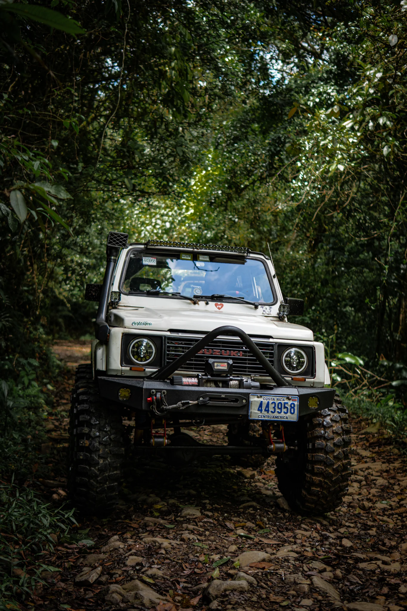 White Suzuki Samurai photographed from the front on a forest trail in Costa Rica