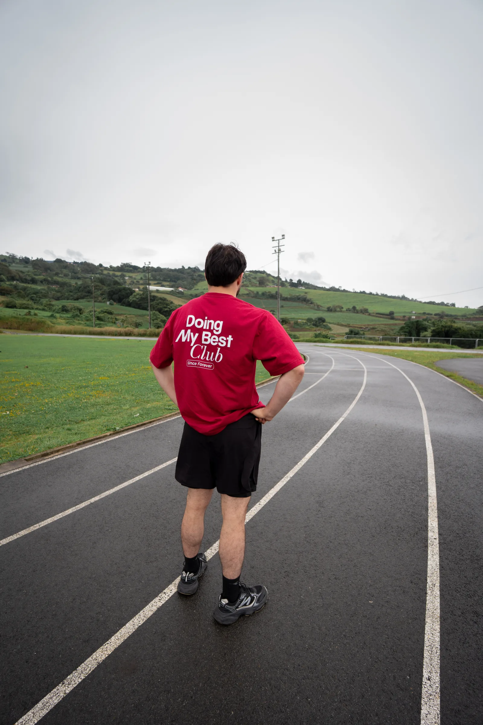 Runner wearing a red MOVA shirt on an outdoor track