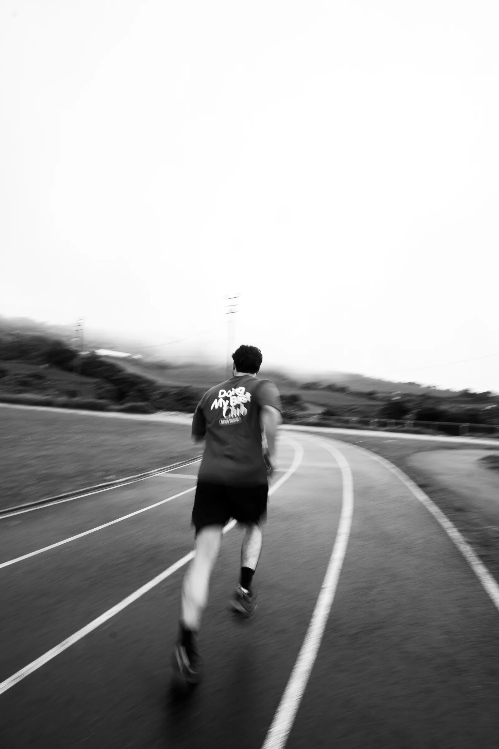 Black-and-white motion photograph of a runner wearing MOVA sportswear