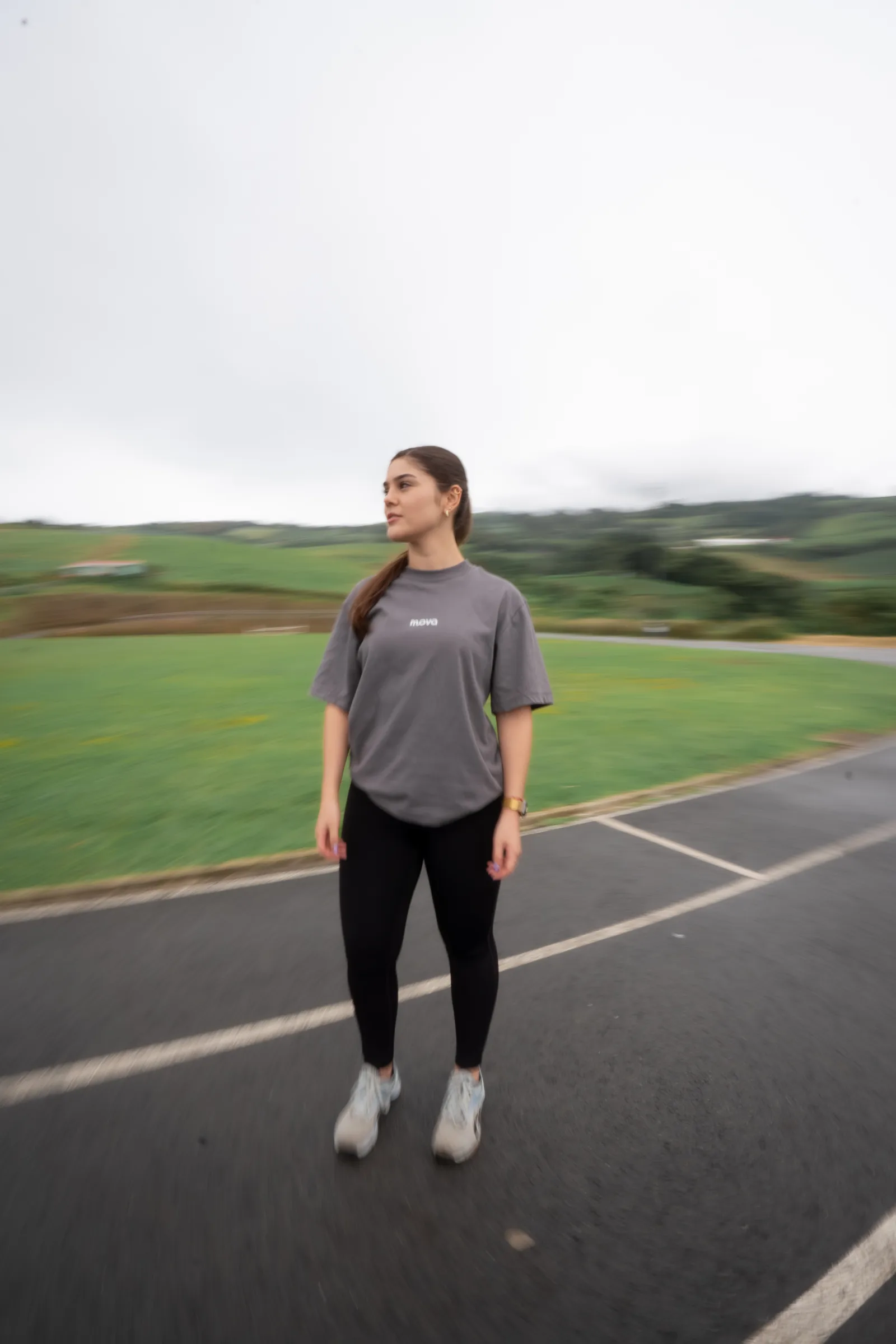 Athlete in a gray MOVA shirt surrounded by a motion-blurred landscape