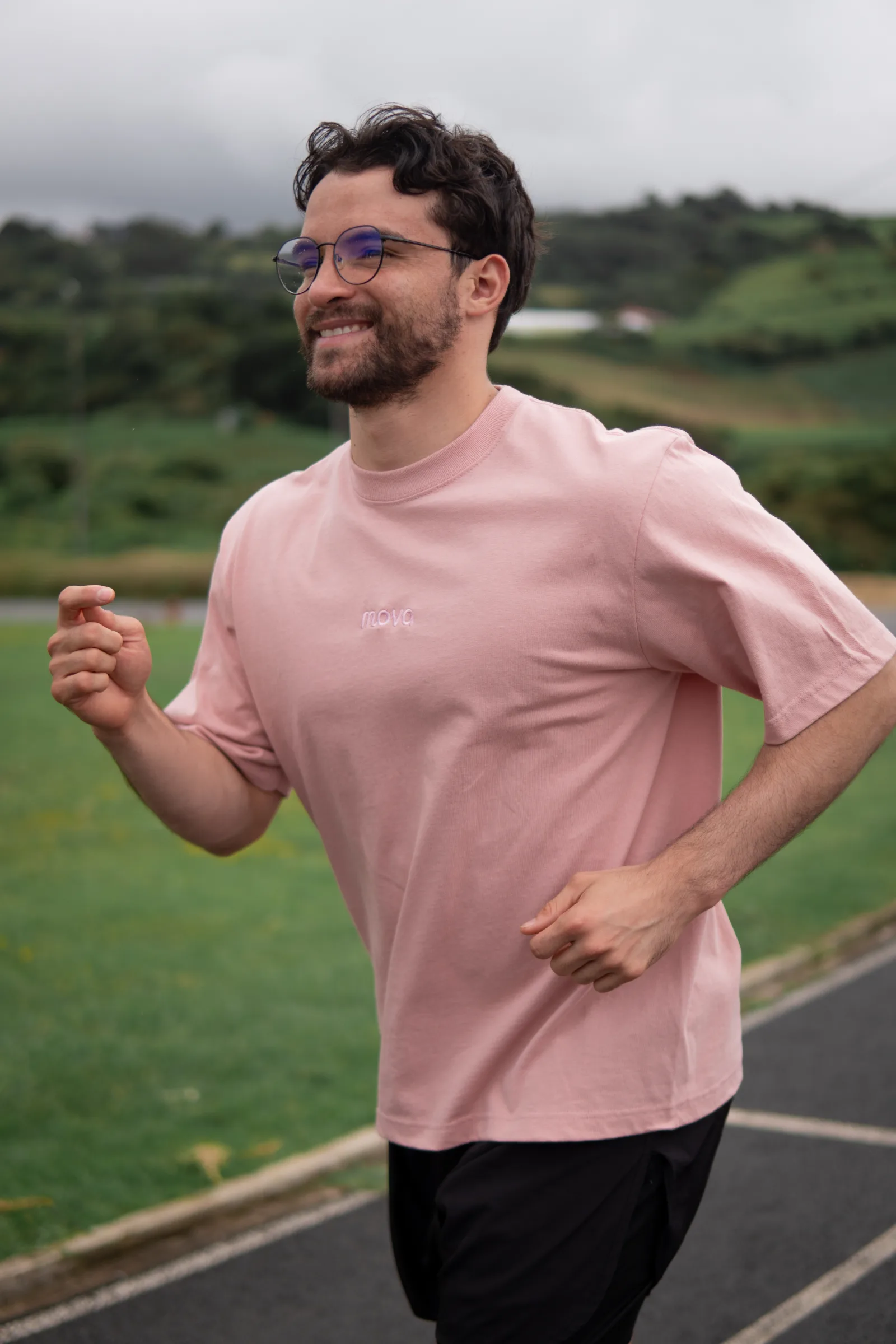 Runner wearing a pink MOVA shirt outdoors