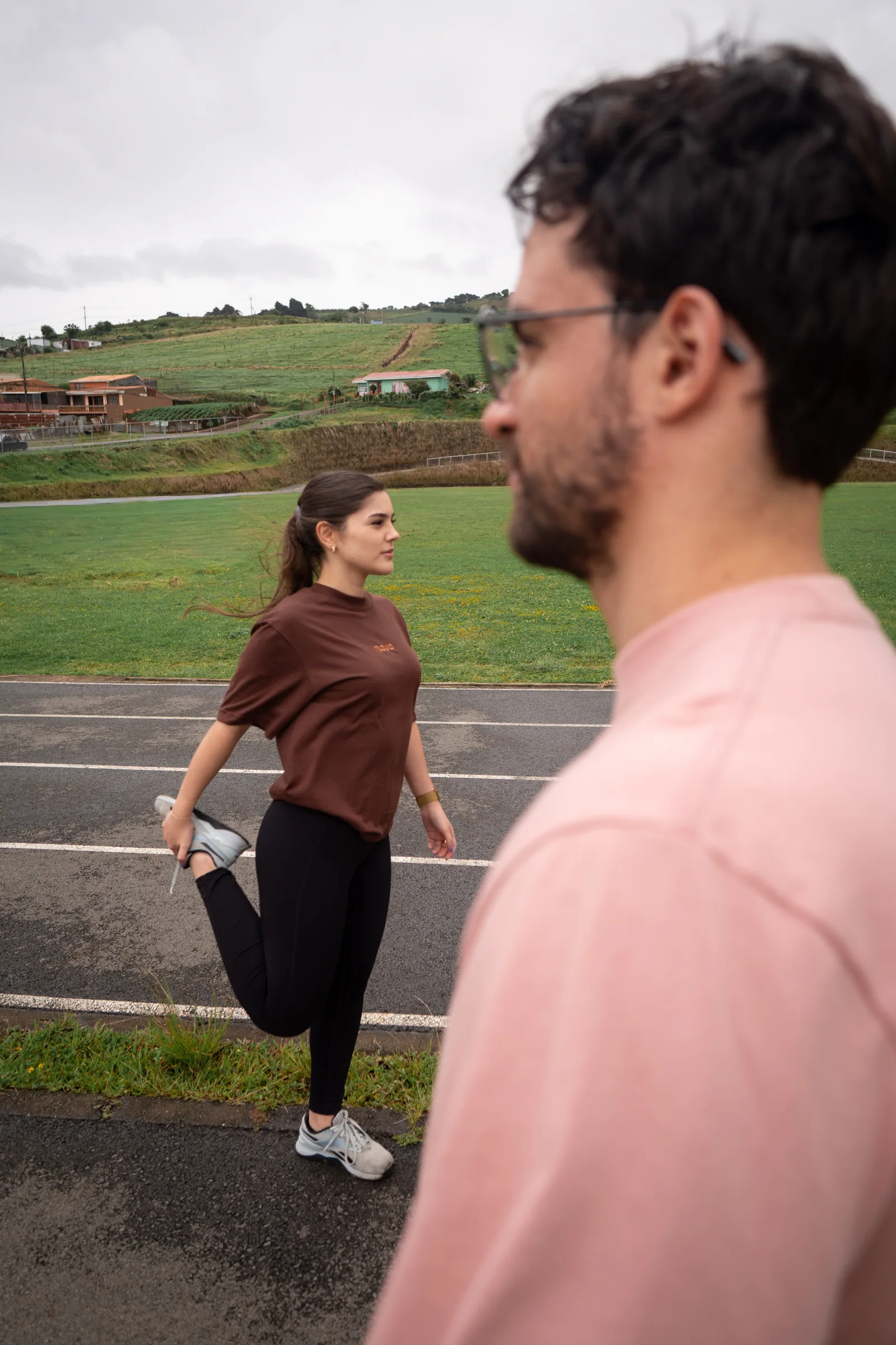 Two athletes in MOVA sportswear preparing beside an outdoor track