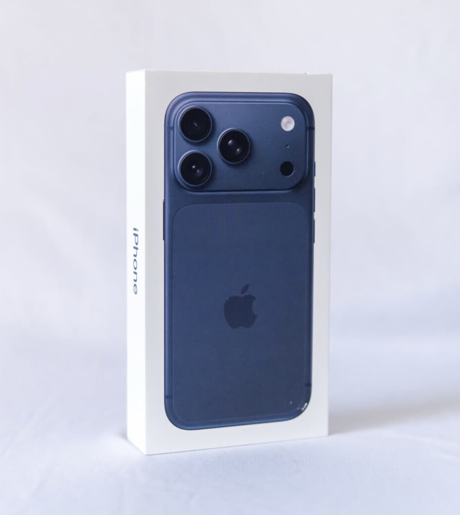 Blue iPhone box photographed on a white background