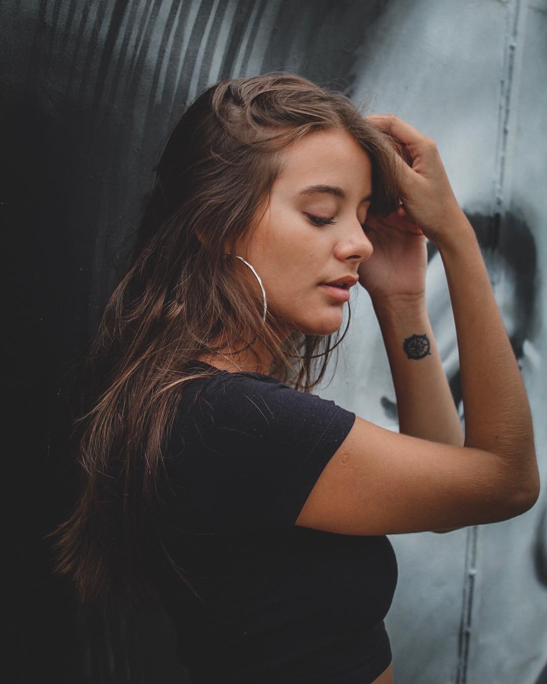 Urban portrait beside a painted wall
