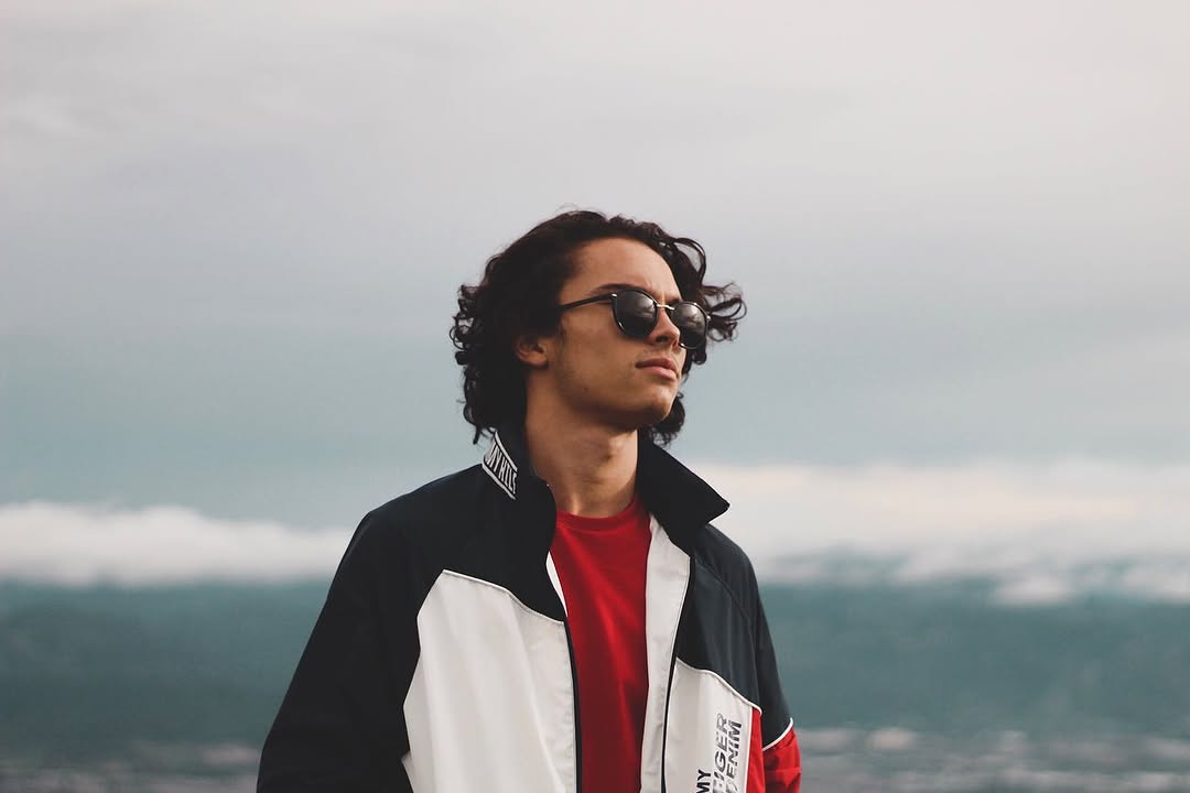 Portrait in sunglasses with misty mountains behind