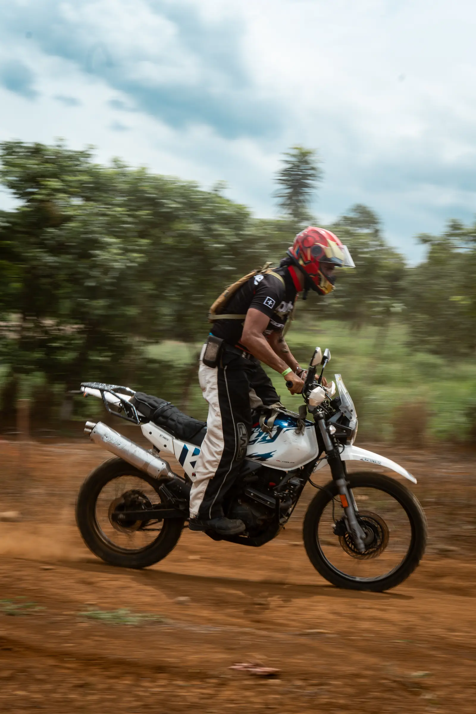 Rider in a red helmet moving across the off-road track
